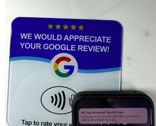 A phone tapping a Ground Up NFC review card, with the NFC tag detected instantly